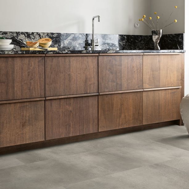 brown wooden kitchen with dark grey vinyl tile flooring from Pergo